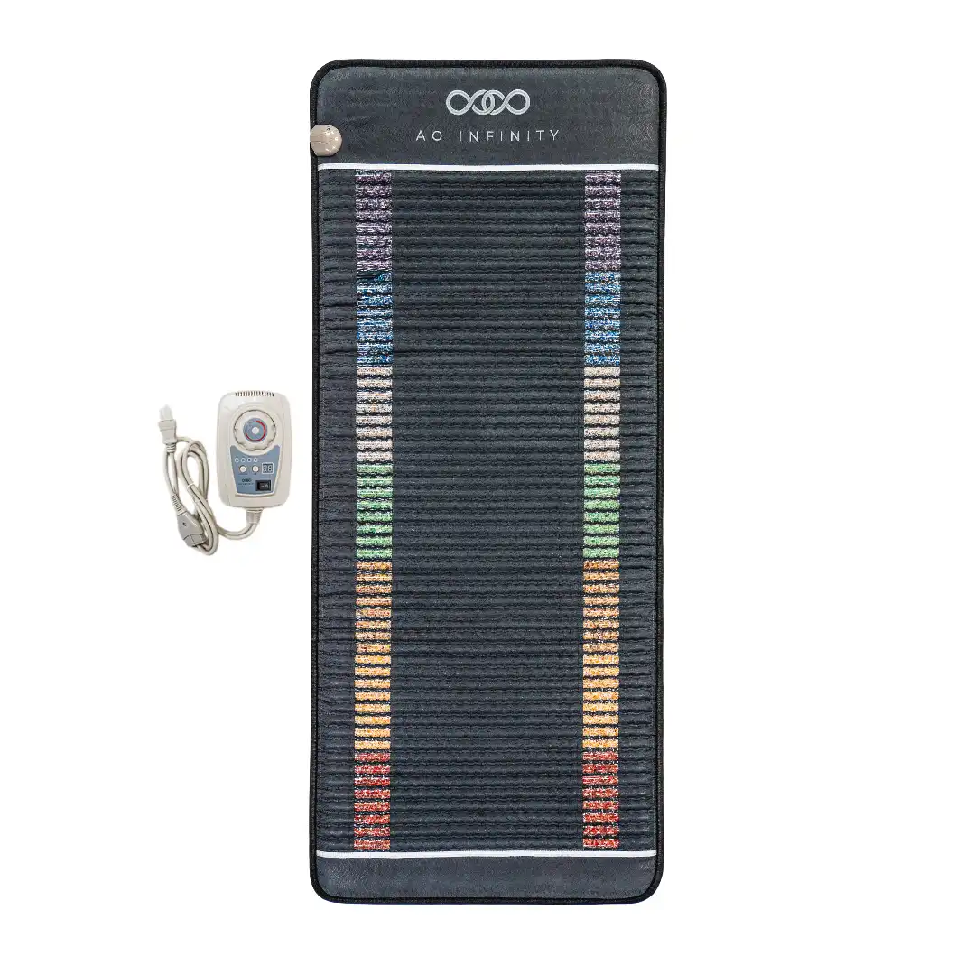 Infinity_Mat_transformative_relaxation_device_at_Bliss_Bash A black AO Infinity Mat with colorful stripes and a digital remote control attached, displayed on a white background.